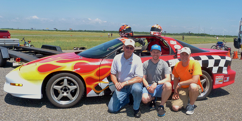 Matt and sons Anthony and Matthew, with team race car