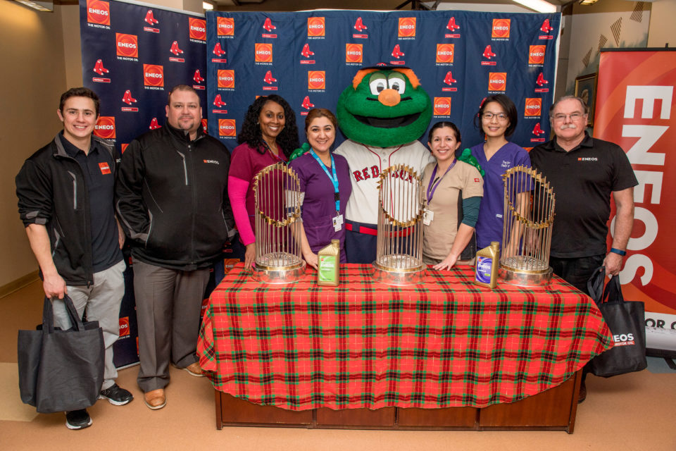 December 7, 2016, Boston, MA: Guests and members of ENEOS pose with the 2004, 2007, and 2013 Boston Red Sox World Series trophies and mascot Wally the Green Monster during an appearance sponsored by ENEOS at the Dimock Center in Boston, Massachusetts Wednesday, December 7, 2016. (Photos by Billie Weiss/Boston Red Sox)