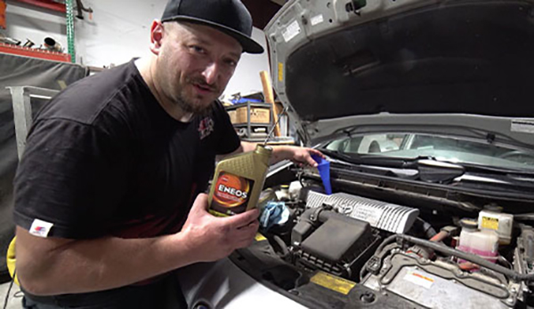 Mechanic holding ENEOS Oil