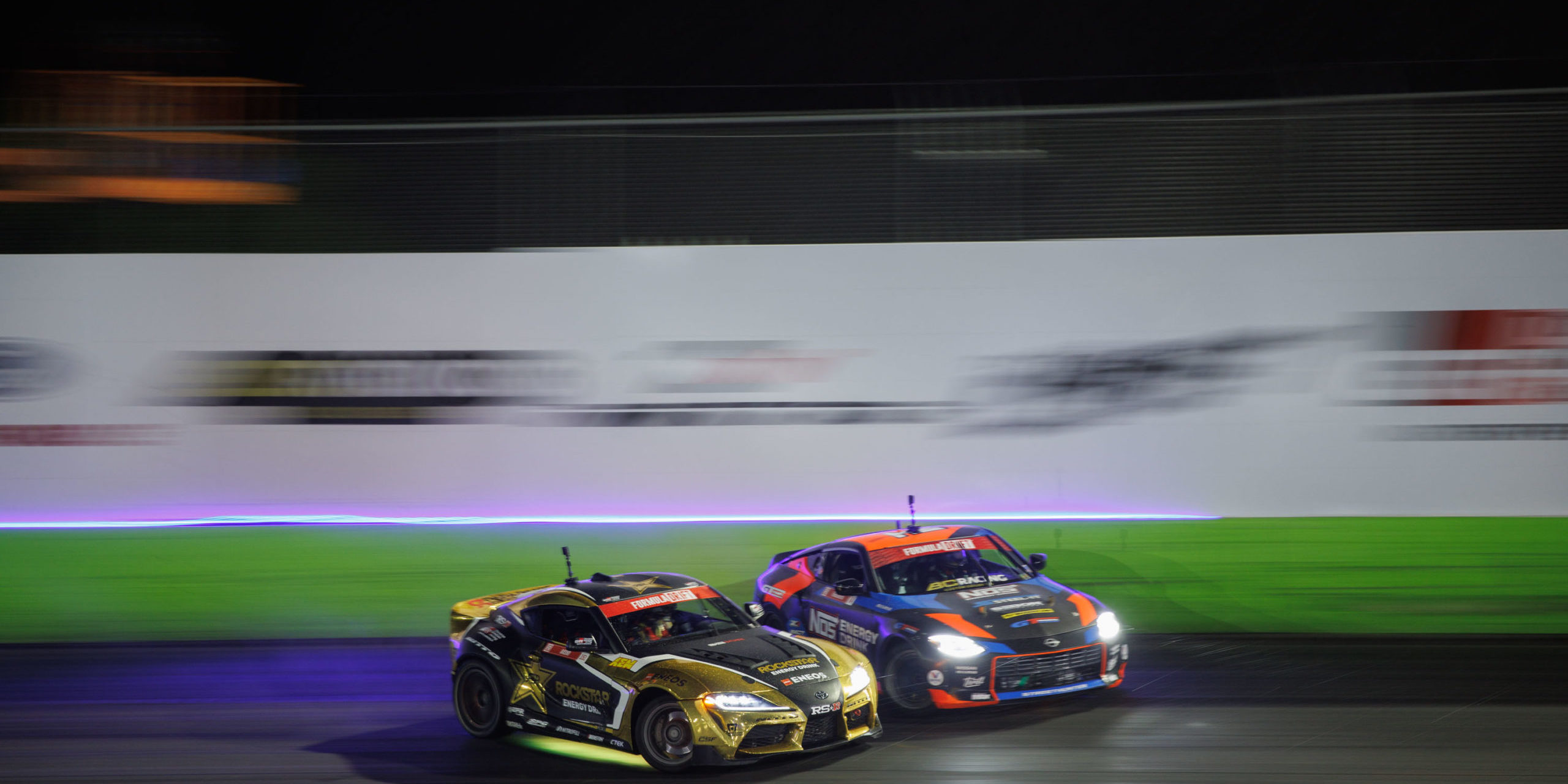 two cars turning together on track