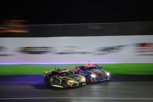 two cars turning together on track