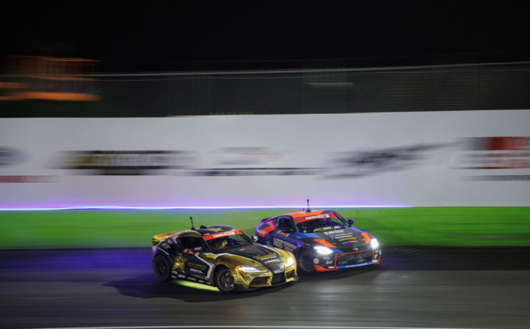 two cars turning together on track