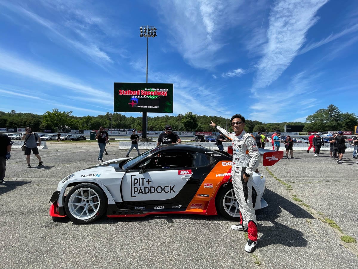 Dai Yoshihara in racing gear and with Pit Paddock car