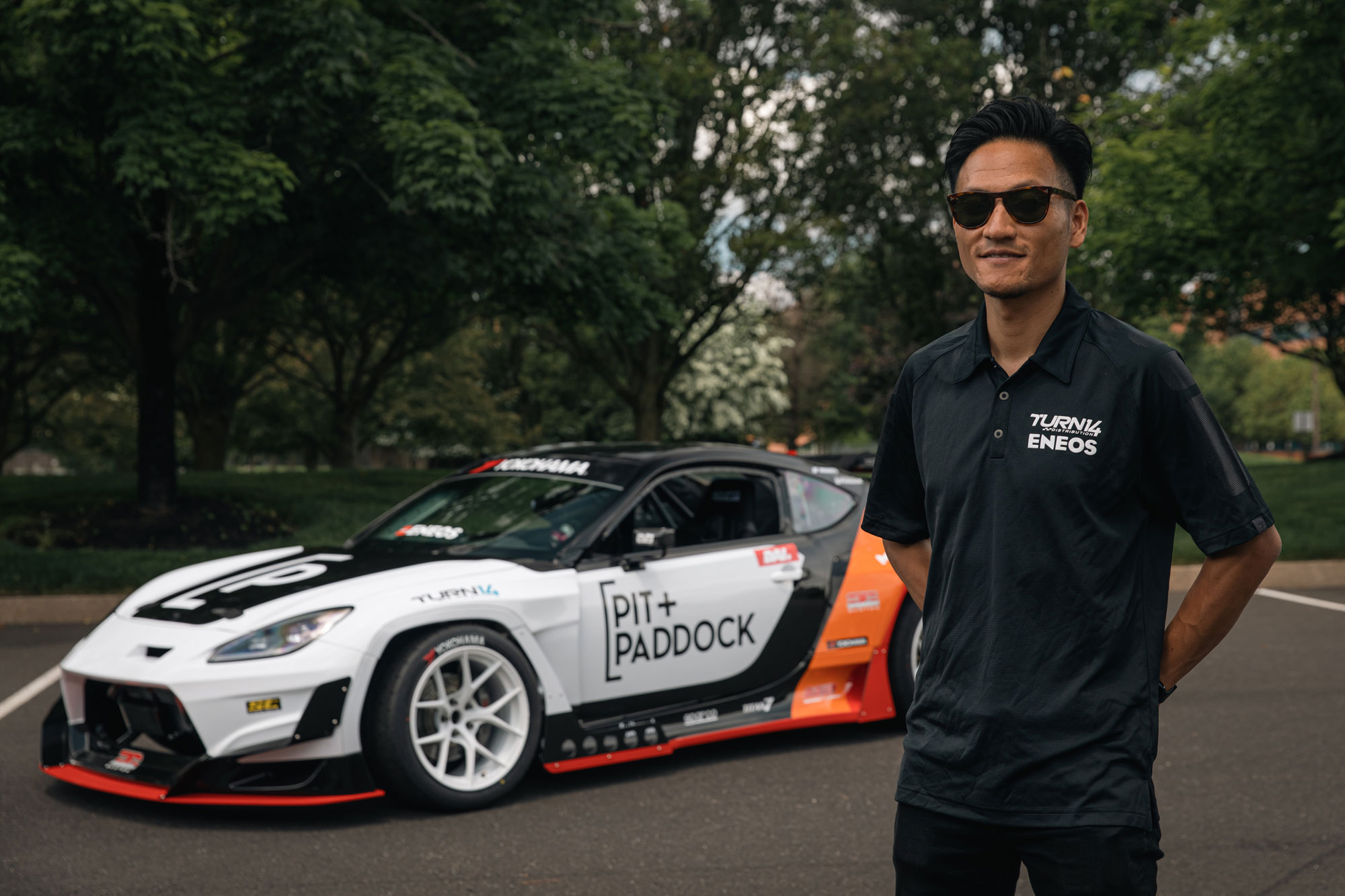 Dai Yoshihara Standing in front of Pit Paddock Subaru Car