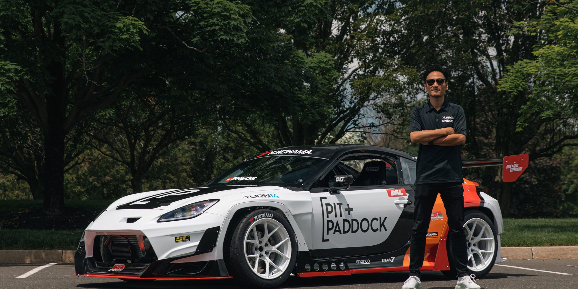 Dai Yoshihara Standing with Pit Paddock Subaru Car