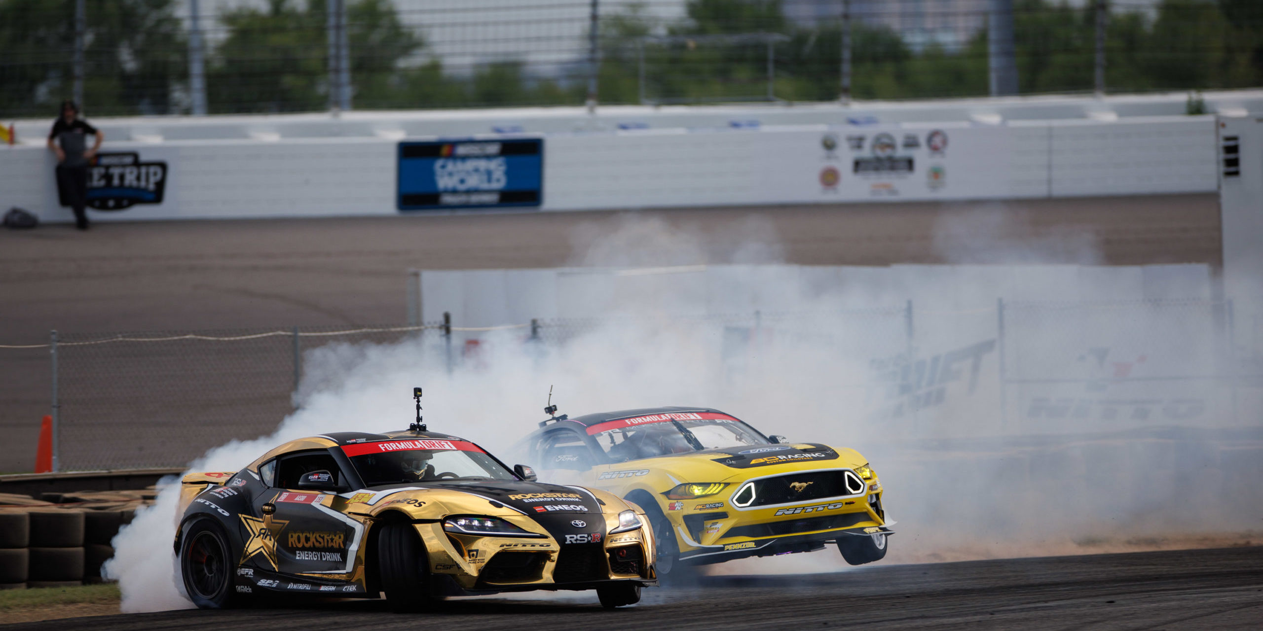 Two golden drift race cars turning