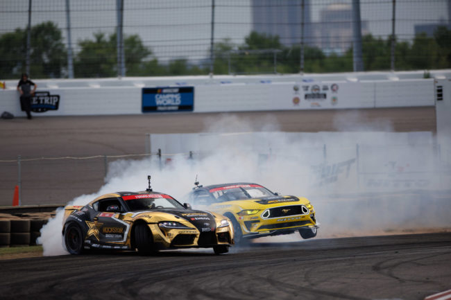 Two golden drift race cars turning