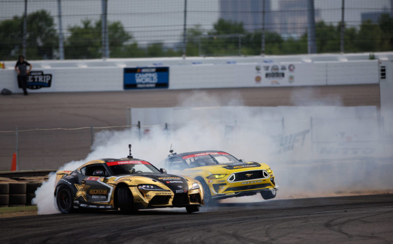 Two golden drift race cars turning
