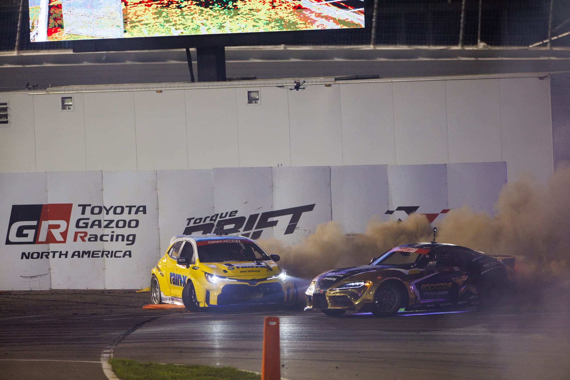 Two golden drift race cars on track