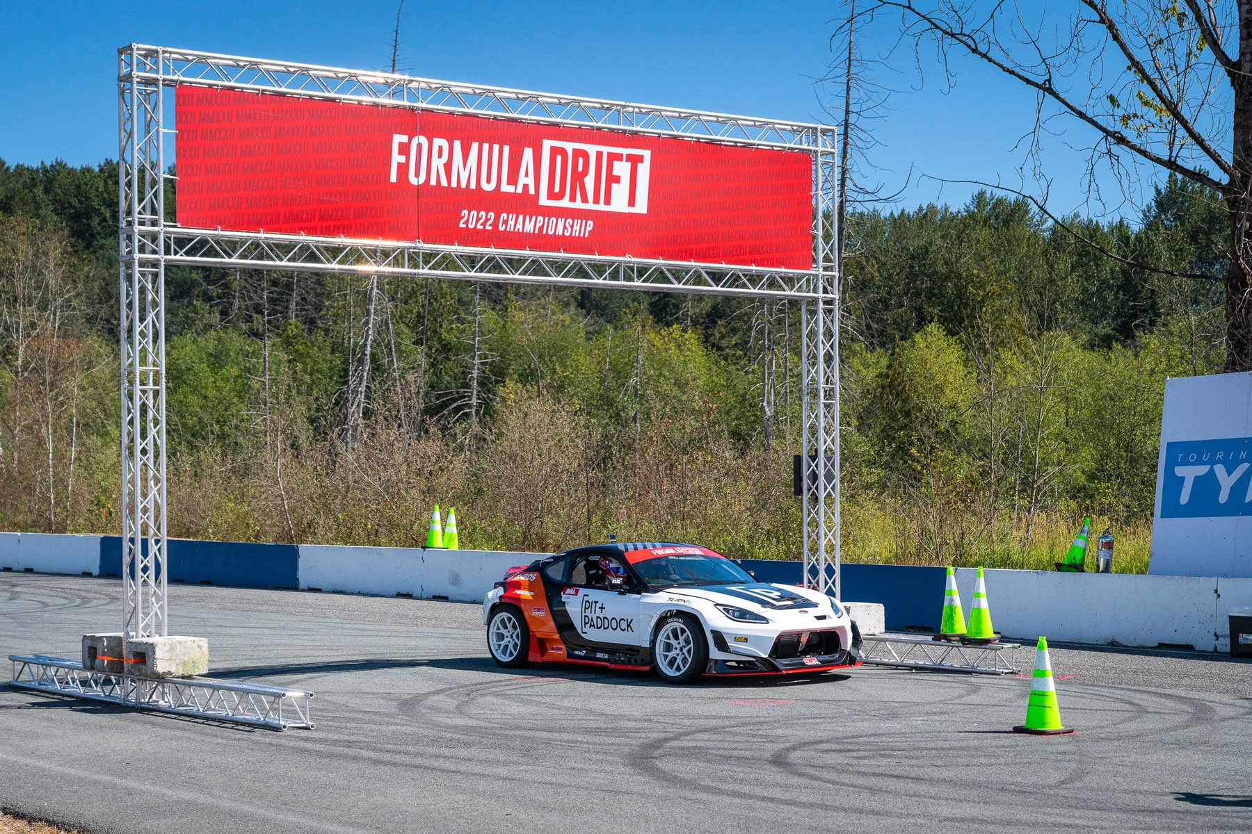 Pit+Paddock race car under Formula Drift banner Pit+Paddock race car under Formula Drift banner