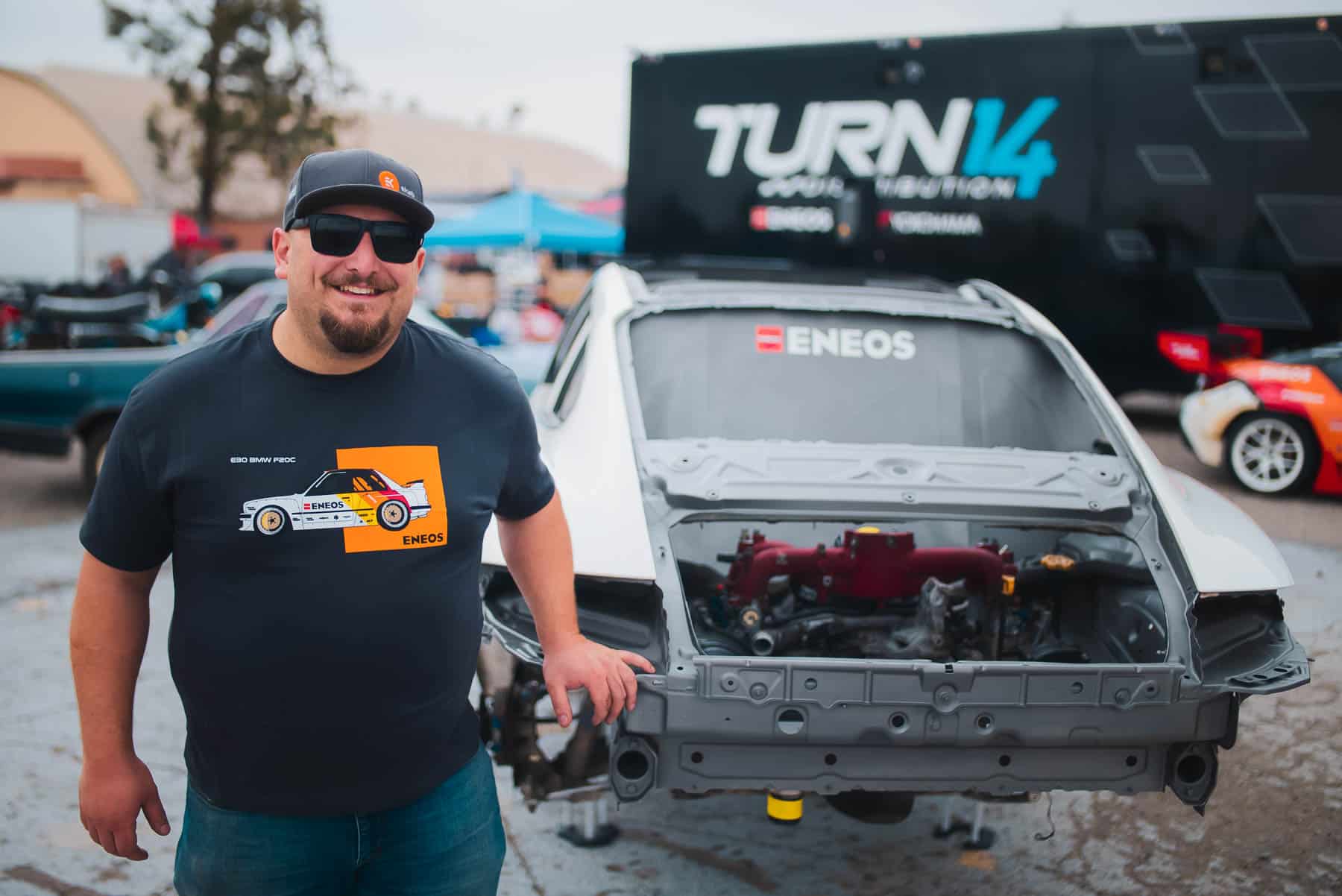 Faruk standing in front of car frame