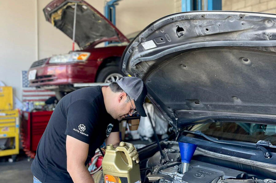 V&E Auto Repair employee using ENEOS oil on car