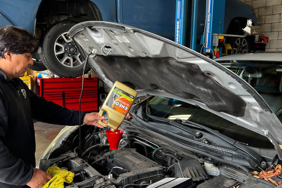 V&E Auto Repair employee using ENEOS oil on car