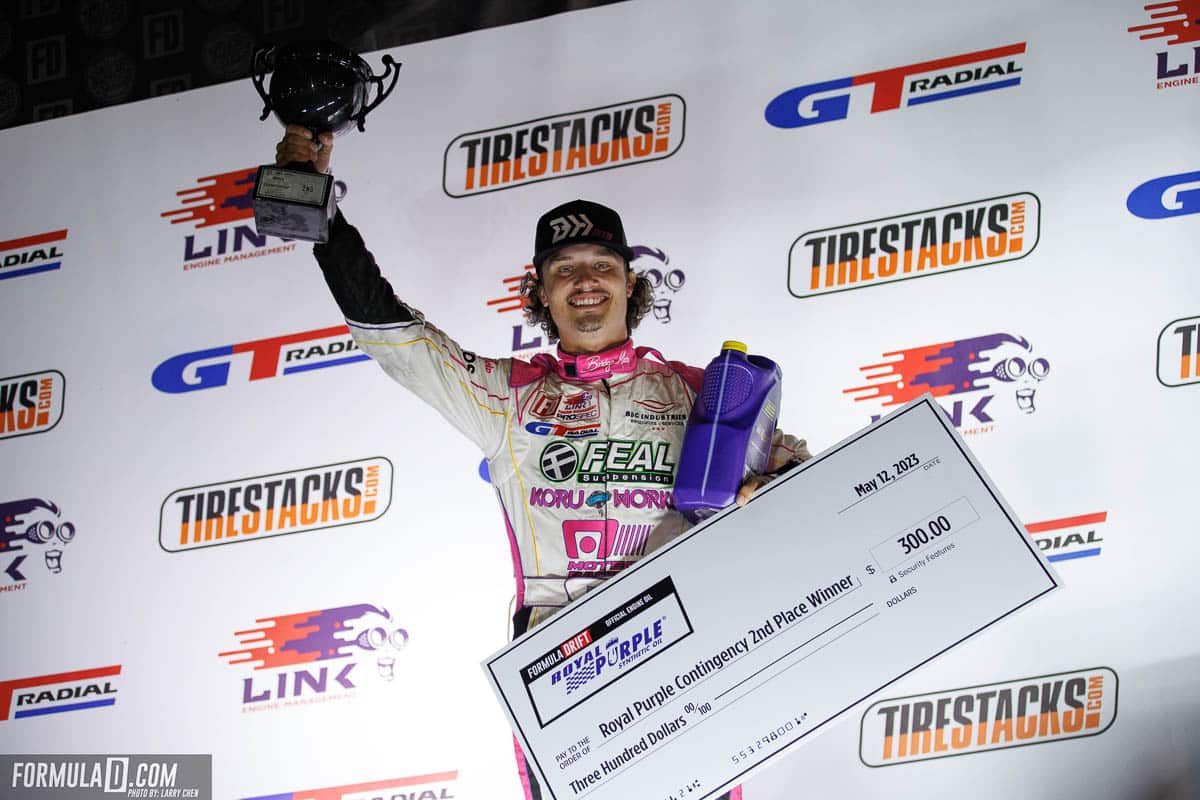 Formula DRIFT podium winner with check and trophy