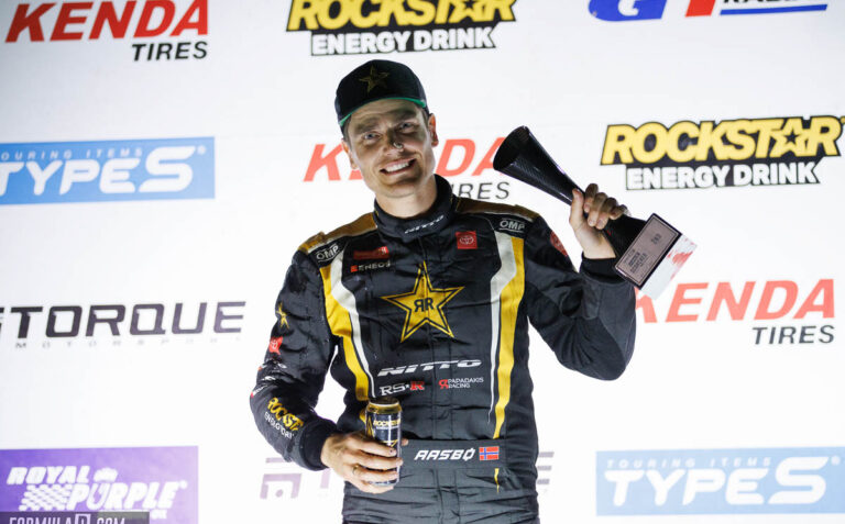 Fredric Aasbo with Trophy on Podium