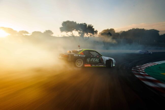 Simen Olsen drifting the Feal Nissan S14.9 down the Laguna Seca Corkscrew.