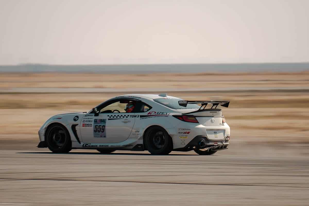 A’PEXi GR86 making a pass on the front straight at Buttonwillow Raceway